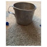 A collectible measuring cup aluminum