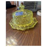 This is a vintage yellow vaseline glass covered