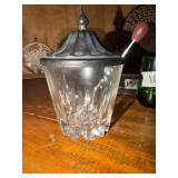 This antique condiment server features a clear