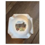 This vintage white ceramic ashtray features a