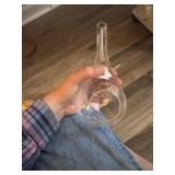 This clear glass teardrop terrarium features a