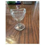 This is a vintage clear glass eye wash cup