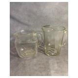 Two Glass Pitchers with Decorative Patterns