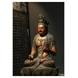 A TANG DYNASTY WOODCARVING OF A BODHISATTVA...