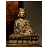 A GILDED BRONZE STATUE OF A MASTER FROM THE...