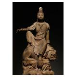 A WOODCARVING OF MANJUSRI BODHISATTVA FROM THE...