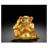 A GILDED BRONZE STATUE OF A WEASEL FROM THE...