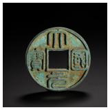 A LARGE COIN WITH A DRAGON PATTERN ON THE BACK,...