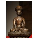 A GILDED BRONZE PORTRAIT OF A MASTER FROM THE...