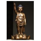 A GILDED BRONZE FIGURE OF SAKYAMUNI IN THE MING...