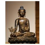 A SITTING STATUE OF THE MEDICINE BUDDHA IN...