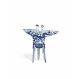 A BLUE AND WHITE THREE-LEGGED CUP FROM YONGLE...