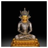 A QING DYNASTY GILDED SILVER STATUE OF THE...