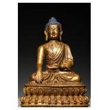 A GILDED BRONZE STATUE OF SAKYAMUNI BUDDHA FROM...