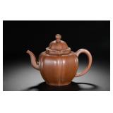 A SIX-PETAL RHOMBUS-SHAPED PURPLE CLAY TEAPOT...