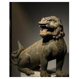 A PAINTED CROUCHING LION FIGURINE CARVED FROM...