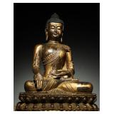 A MING DYNASTY STATUE OF SAKYAMUNI BUDDHA