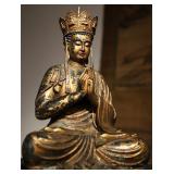 A GILDED BRONZE STATUE OF THE KING OF TIBETAN...