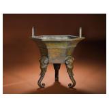 A BRONZE HEXAGONAL ELEPHANT-FOOTED EAR-SHAPED...