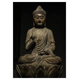 A SEATED STATUE OF SAKYAMUNI MADE OF NANMU WOOD...
