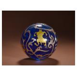 A ROUND BALL WITH INLAID GOLD AND SILVER...