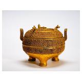 A THREE-LEGGED COVERED BRONZE TRIPOD WITH...