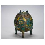 A FOOTBALL-SHAPED COVERED TRIPOD INLAID WITH...