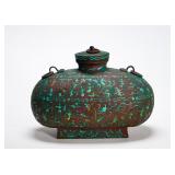 A FLAT POT WITH TURQUOISE INLAID PATTERNS OF...
