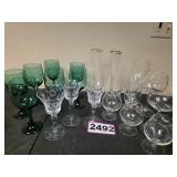 Assortment of Clear and Green Stemmed Glassware
