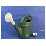 Green Plastic Watering Can with White Rose