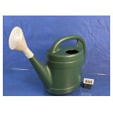 Green Plastic Watering Can with White Rose