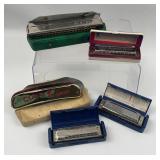 An Assortment of Five Hohner Harmonicas