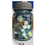 1 VINTAGE BLUE JAR WITH MIXED VINTAGE MARBLES