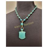 turquoise howlite turtle pendant on necklace
