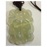 jade green carved fish pendant on necklace
