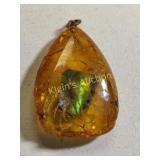 rare ammolite gemstone pendant in amber