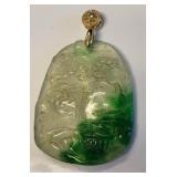 carved pendant w/ gold colored bail set w/small s