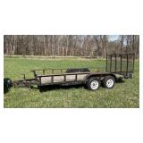 Long flat bed trailer with tall drop down gate ramp