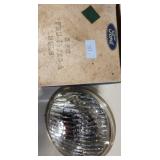Lot 191: NOS FOMOCO ROADLAMP BULB FOR THE 1956 LINCOLN PREMIERES WITH ACCESSORY ROADMAPS!