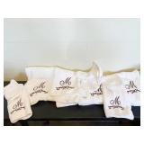 4 BATH AND 4 WASH CLOTHES AND 2 MONOGRAMED "M"