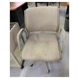 TAN UPHOLSTERED ARMCHAIR ROLLING