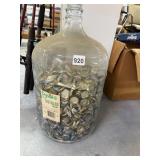 GLASS BOTTLE FILLED WITH BOTTLE CAPS