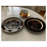 UNMARKED BLACK AND GOLD PLATES WITH POPPY FLOWERS