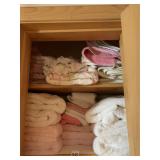 2 SHELVES FULL OF WHITE AND PINK TOWELS