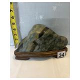 POLISHED WATER STONE ON WOOD PEDESTAL