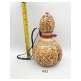 CARVED IN HAND PAINTED GOURD WITH LEATHER STRAP