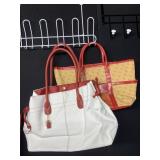 2 E A PURSES ONE HAS SOME DAMAGE ON PIPING STRAP