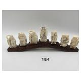 INTRICATELY CARVED 7 BONE FIGURES ON WOOD HOLDER