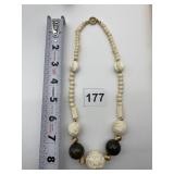 CARVED BONE NECKLACE W/ WOOD SPACERS AND GOLD