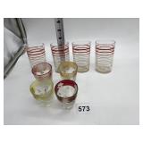 4 SHOT GLASSES AND 4 RED AND WHITE RIMMED GLASSES